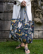 Person holding a floral-patterned bag against a stone wall background