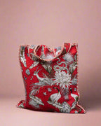 Red patterned pouch against a stone wall