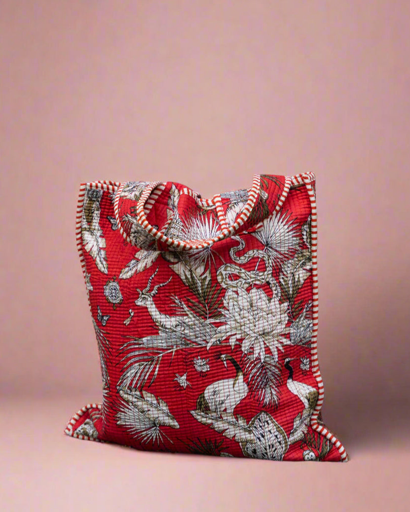 Red patterned pouch against a stone wall